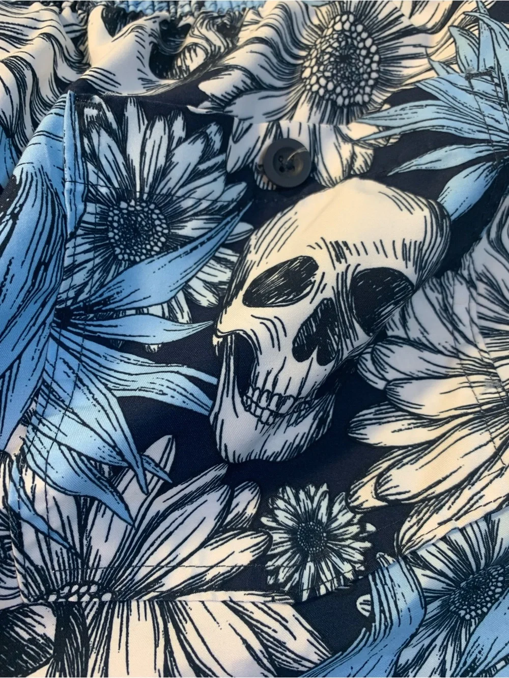 No Boundaries swim trunks feature a distinctive skull and floral pattern. SZ L